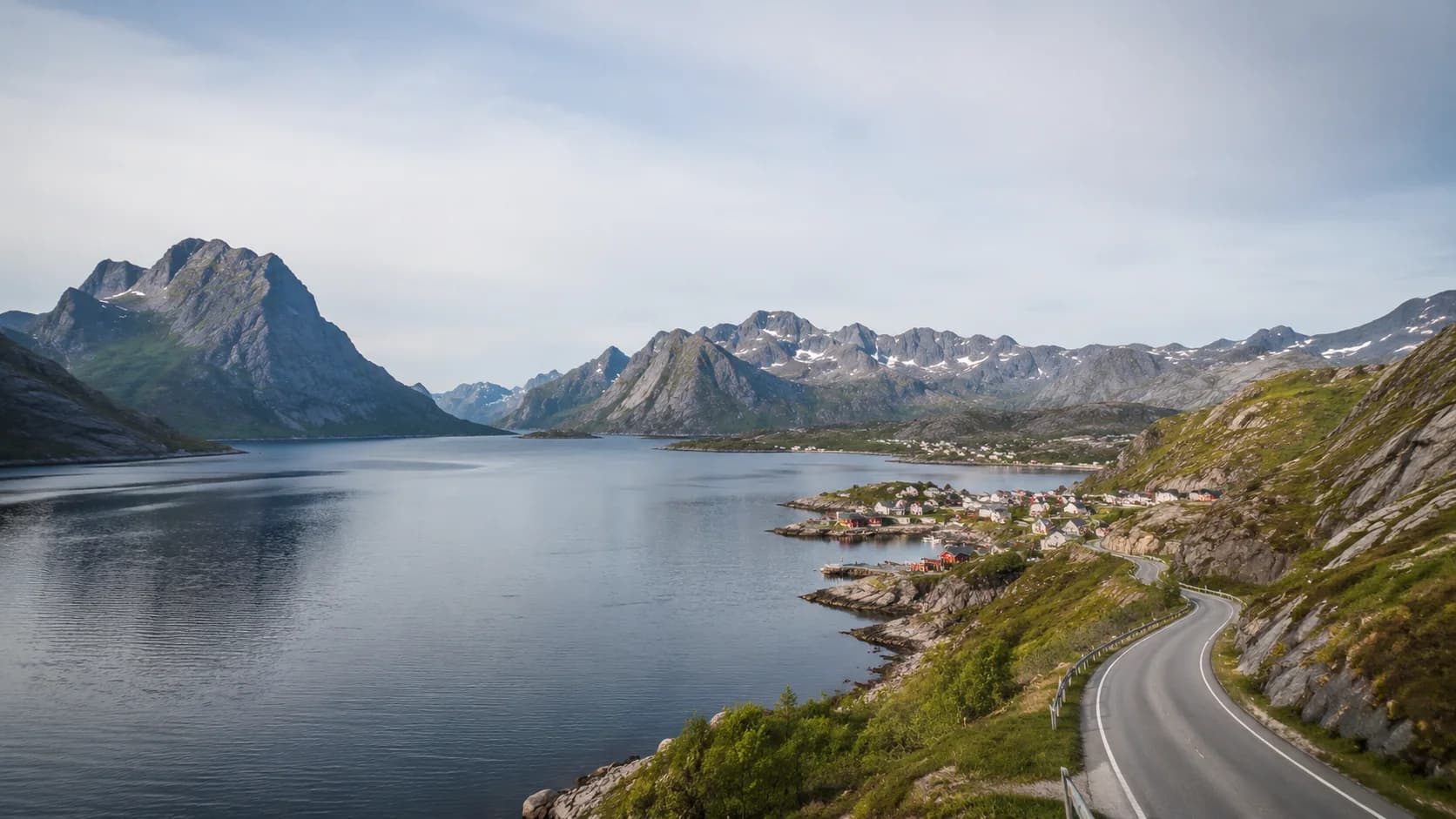 Norwegian fjord, mountain road and coastal settlement in natural daylight