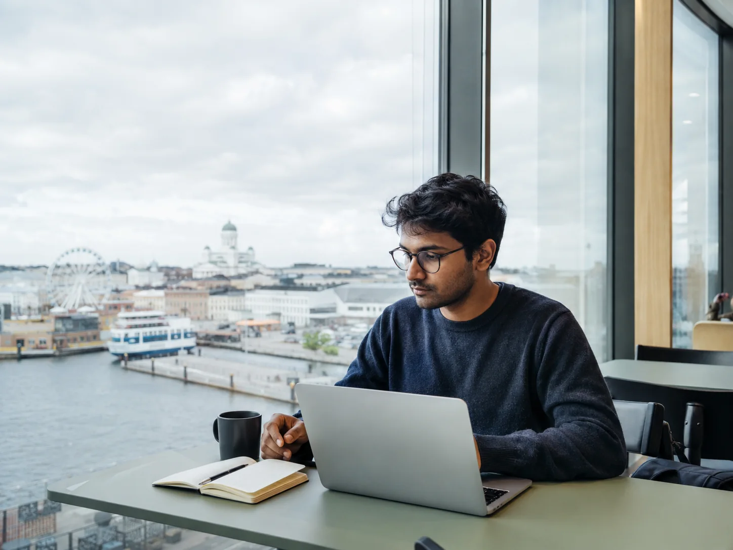 Professional working beside Helsinki harbour in a modern Nordic office